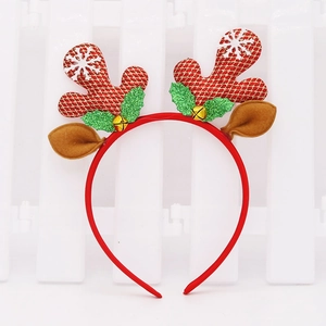 Detail of Christmas reindeer antler headband with festive red glitter and gold bells