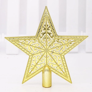 Close-up of golden hollow star Christmas tree topper with intricate carved patterns
