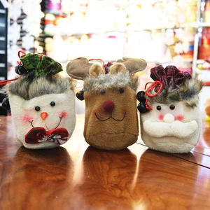 Plush Christmas drawstring gift bags featuring Santa, elk, and snowman on wooden table