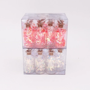 Detail of LED glass bottle string lights filled with pink sequins in PVC boxes