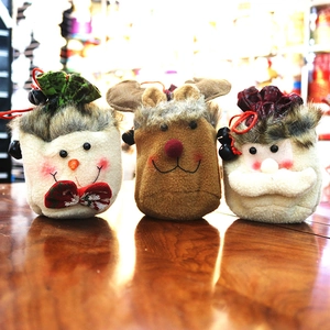 Detailed view of handmade plush Christmas gift bags with Santa, Elk, and Snowman designs