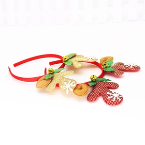Close-up of glittery gold and red plaid reindeer antlers with bells and snow flakes