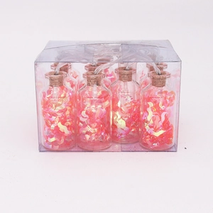 Detail of LED bottle fairy lights with pink sequins in transparent gift packaging box
