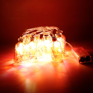 Detail of warm LED glass bottle lights with cork stoppers for Christmas tree decoration