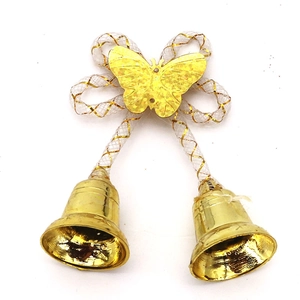 Close-up of golden Christmas bells with white grid bow and butterfly ornament decoration
