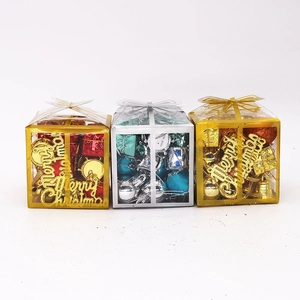 Detailed view of red, silver and gold Christmas gift box ornaments with glitter letters