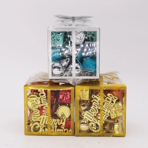 Close-up of stacked gold and silver Christmas ornament sets with festive decorations