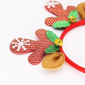 Macro detail of Christmas headband with red gold antlers, glitter leaves and tiny bells