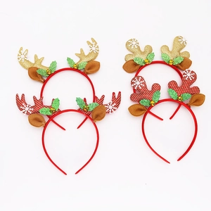 Flat lay detail of four Christmas headbands with glitter antlers, bells and plaid patterns