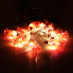 Close-up of LED glass jar string lights with glowing orange crystals for Christmas