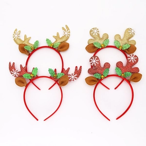 Detail of Christmas reindeer headbands with glitter antlers, red ears and gold bells