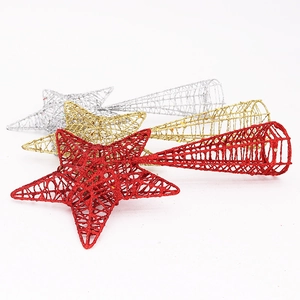 Close-up of glittery red, gold, and silver star tree toppers with hollow wire design