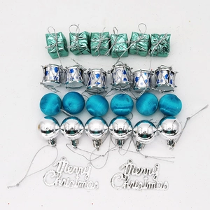 Flat lay of 26-piece Christmas tree ornament set including blue balls and silver drums