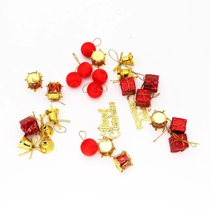 Detail of red and gold Christmas tree ornaments including bells and Merry Christmas sign