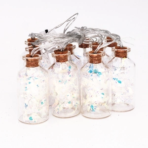 Close-up of glass bottle LED string lights with corks and colorful laser paper filling