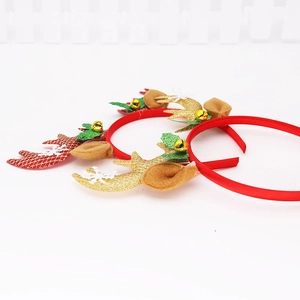 Detail eines Weihnachts-Haarreifens mit Glitzer-Rentiergeweih und goldenen Glöckchen