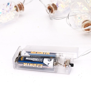 Macro detail of LED bottle string light battery box with manual power switch