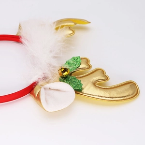 Detailed macro view of Christmas reindeer antlers headband with gold bell and holly leaves