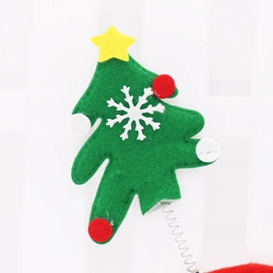 Detail of Christmas tree headband part with green felt, white snowflakes and metal spring