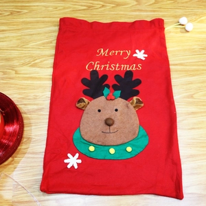 Detail of red Christmas gift bag with a 3D reindeer patch and Merry Christmas text
