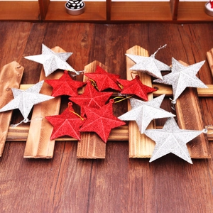 Macro shot of red and silver glittery star ornaments on a rustic wooden background