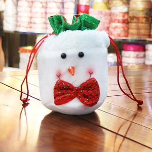 Detail of plush snowman Christmas candy bag with red sequin bow and green drawstring