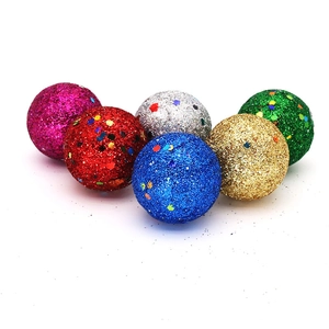 Close-up of glittery Christmas tree ornaments with colorful sequins in six various colors