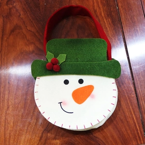Detail of a handmade thick felt snowman Christmas gift bag with festive green hat