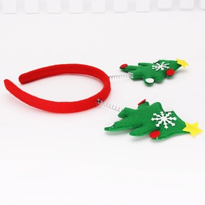 Close-up of Christmas headband with green felt trees on springs and white snowflakes
