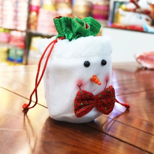 Christmas snowman drawstring gift bag made of white plush fabric with a festive red ribbon
