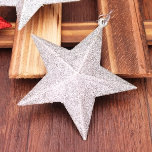 Macro shot of sparkling silver glitter star ornament on rustic wooden background