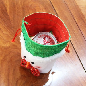 Detail showing soft snowman drawstring gift bag with plush texture and red inner lining
