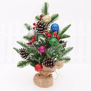Mini Christmas tree with glitter balls, pine cones, red berries and burlap base