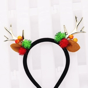 Detailaufnahme von Weihnachts-Rentier-Haarreif mit goldenen Geweihen und Glitzer-Pompons
