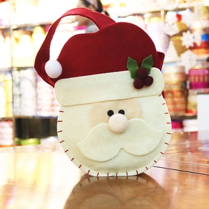 Handmade Santa Claus felt gift bag for Christmas treats with red handles and stitching