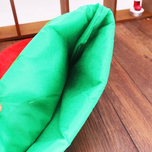 Close-up of thick non-woven texture and internal stitching of green Christmas elf hat