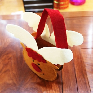 Detail of reindeer felt Christmas gift bag with 3D red nose and sturdy red handle