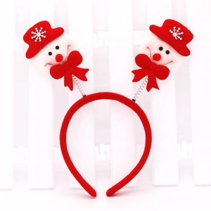 Close-up of Christmas headband with spring-loaded smiling snowmen and red bows