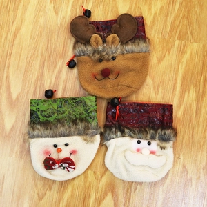 Detailed view of three festive drawstring gift bags featuring Santa, snowman, and reindeer