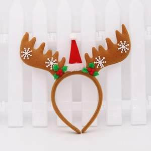 Close-up of reindeer antler headband with mini Santa hat and felt berry details