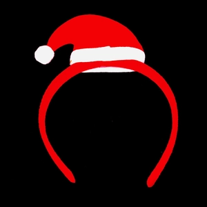 Detail view of a red Christmas headband with a mini Santa hat and white plush pom-pom