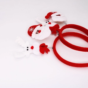 Detail of Christmas headbands with spring-mounted Santa and reindeer on red felt band