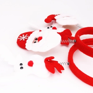 Close-up of Christmas headbands with 3D Santa Claus figures on bouncy metal springs