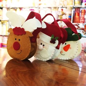 Detailed view of handmade thick felt Christmas gift bags with Santa and Reindeer designs