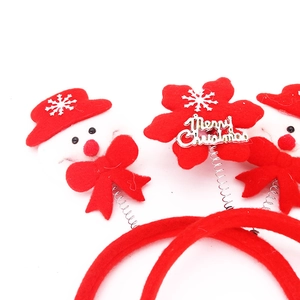 Detailed view of red Christmas headbands with spring snowmen and Merry Christmas snowflakes