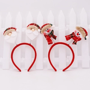 Détail de serre-têtes de Noël avec Père Noël et bonhomme de neige sur ressorts