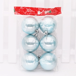 Detail of light blue pearlescent Christmas balls with silver string in transparent packaging