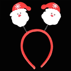 Detail of Christmas headband with springy Santa Claus figures and white snowflake patterns