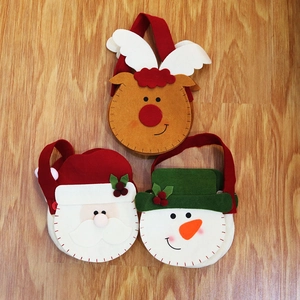 Detailed trio of handmade Christmas felt gift bags featuring reindeer, Santa, and snowman