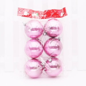 Close-up of 6-piece shiny pink Christmas ball ornaments set in packaging with snowman tag